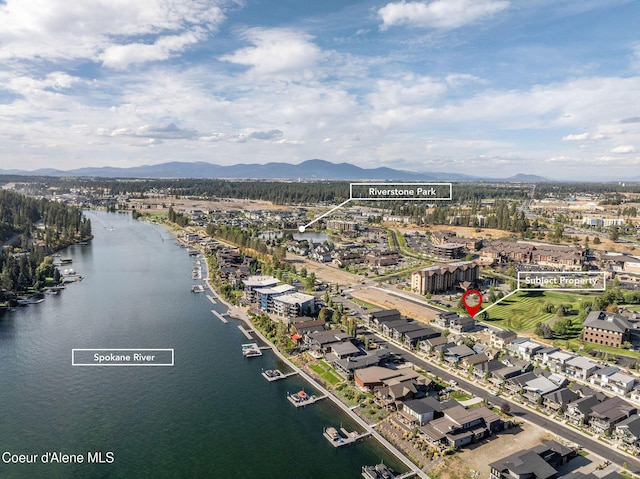 drone / aerial view featuring a water and mountain view