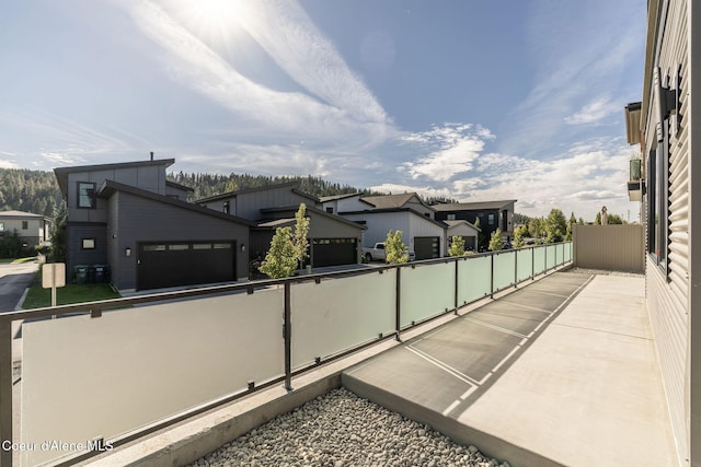 exterior space with a garage, fence, and a residential view