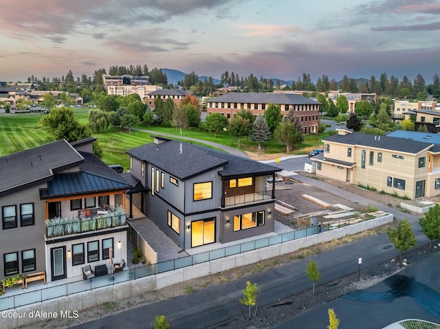 aerial view at dusk featuring a residential view