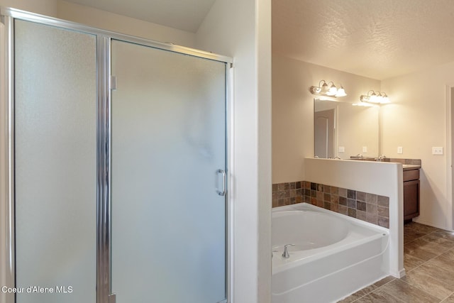 bathroom featuring a garden tub, tile patterned flooring, a textured ceiling, vanity, and a shower stall