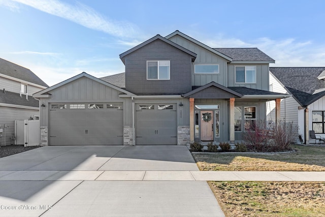 craftsman house featuring board and batten siding, stone siding, roof with shingles, and driveway