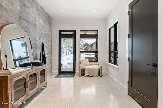 foyer entrance featuring concrete flooring, recessed lighting, and baseboards