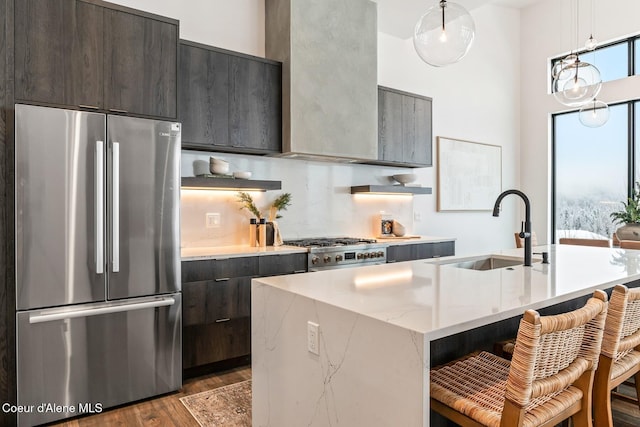 kitchen featuring modern cabinets, stainless steel appliances, a sink, and wood finished floors