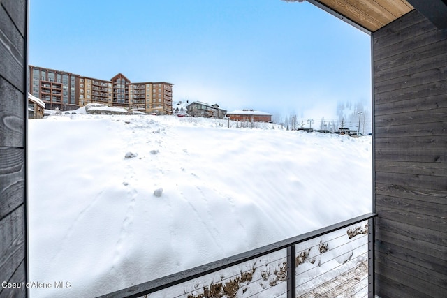 snowy yard with a balcony