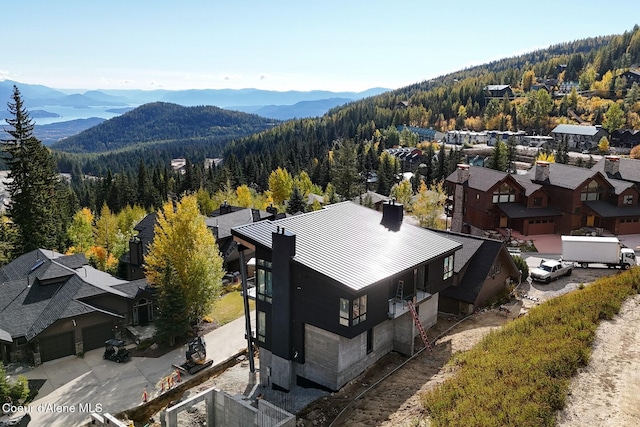 bird's eye view with a mountain view and a forest view