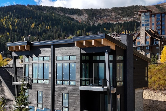 exterior space with a mountain view and a view of trees