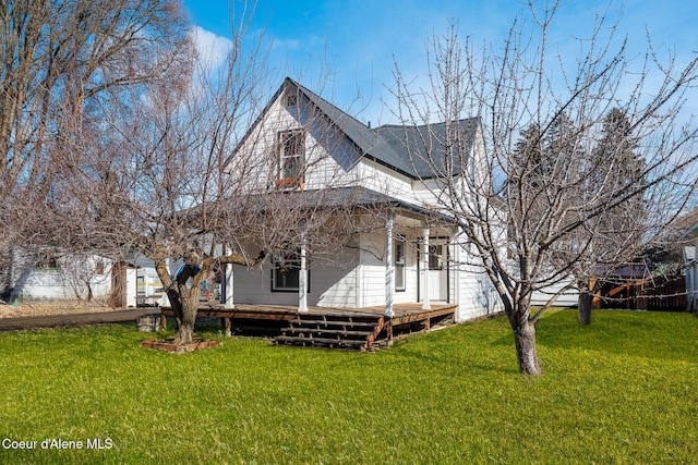 exterior space featuring a shingled roof and a front yard