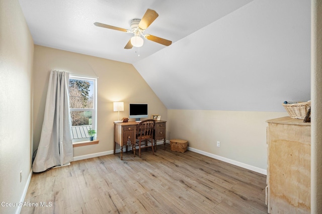 home office with lofted ceiling, ceiling fan, baseboards, and wood finished floors