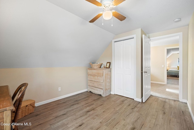 bonus room with vaulted ceiling, baseboards, a ceiling fan, and light wood-style floors