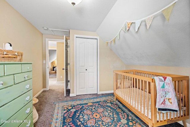 carpeted bedroom with vaulted ceiling, a closet, and baseboards