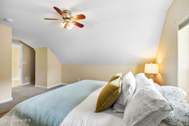 carpeted bedroom with vaulted ceiling, a ceiling fan, and baseboards