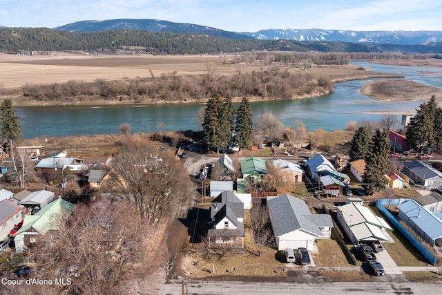 birds eye view of property with a water and mountain view