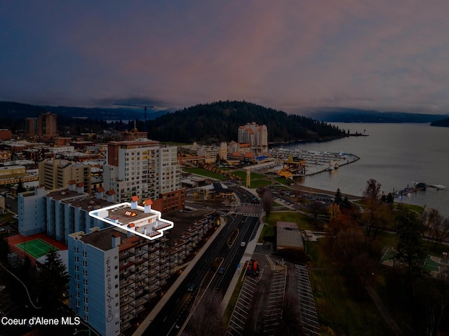 aerial view at dusk with a view of city and a water view