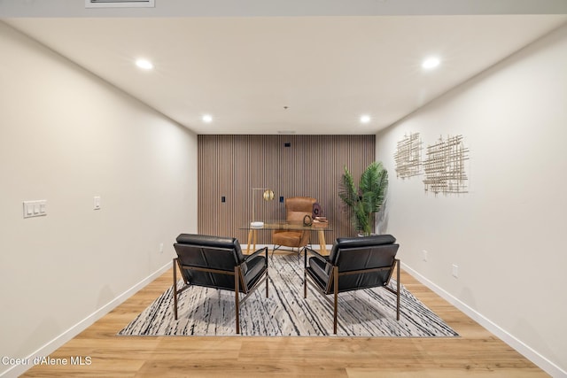 sitting room featuring light wood-type flooring, baseboards, and recessed lighting