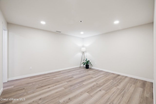 unfurnished room with light wood-style floors, recessed lighting, visible vents, and baseboards