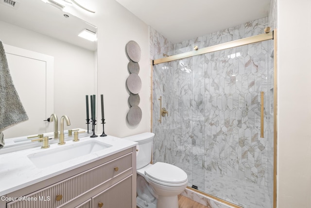 full bathroom with visible vents, a marble finish shower, vanity, and toilet