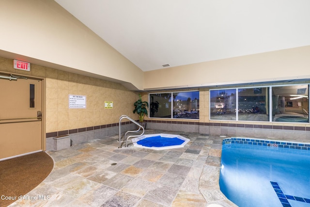 view of pool with an indoor hot tub