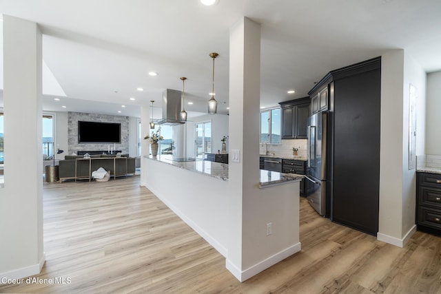 301 N 1st St # 930, Coeur Dalene, ID 83814 - kitchen featuring light wood-style floors, light stone countertops, stainless steel appliances, and island exhaust hood