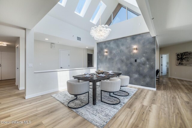 301 N 1st St # 930, Coeur Dalene, ID 83814 - dining room with visible vents, wood finished floors, baseboards, a notable chandelier, and a skylight