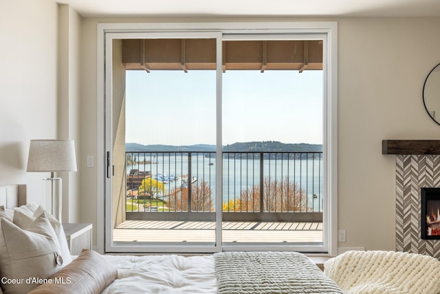 301 N 1st St # 930, Coeur Dalene, ID 83814 - bedroom featuring a tile fireplace, multiple windows, and access to exterior