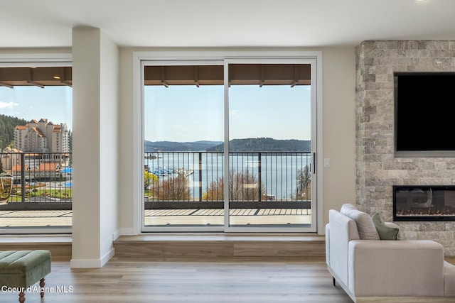 301 N 1st St # 930, Coeur Dalene, ID 83814 - living area featuring baseboards, plenty of natural light, a fireplace, and wood finished floors