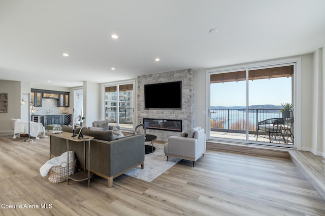 301 N 1st St # 930, Coeur Dalene, ID 83814 - living room with a stone fireplace, recessed lighting, and light wood-type flooring
