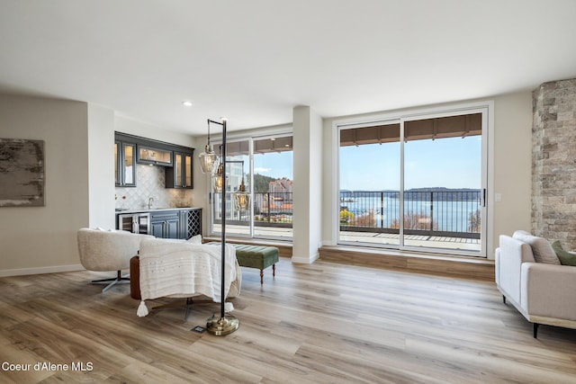 301 N 1st St # 930, Coeur Dalene, ID 83814 - living room with indoor wet bar, light wood-style floors, and baseboards