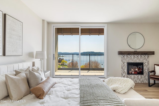 301 N 1st St # 930, Coeur Dalene, ID 83814 - bedroom with a fireplace, wood finished floors, multiple windows, and access to exterior