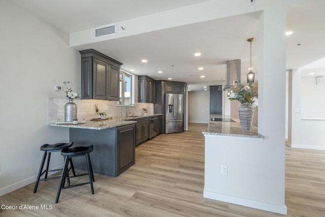 301 N 1st St # 930, Coeur Dalene, ID 83814 - kitchen with visible vents, a sink, a peninsula, and high quality fridge