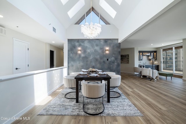 301 N 1st St # 930, Coeur Dalene, ID 83814 - dining space with visible vents, a skylight, wood finished floors, baseboards, and a notable chandelier