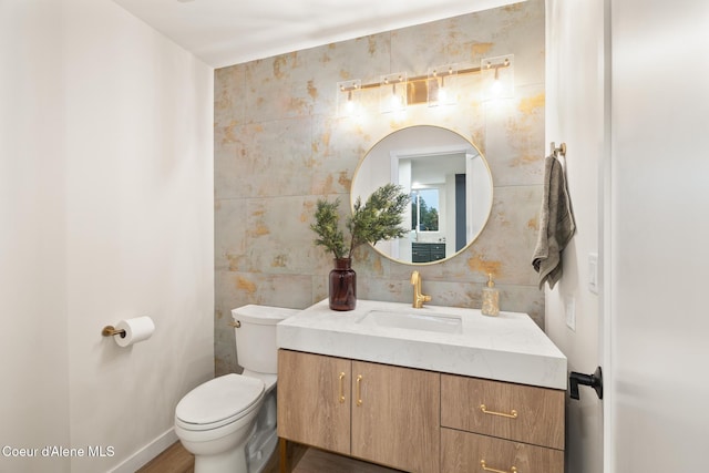301 N 1st St # 930, Coeur Dalene, ID 83814 - bathroom with tile walls, vanity, toilet, and wood finished floors