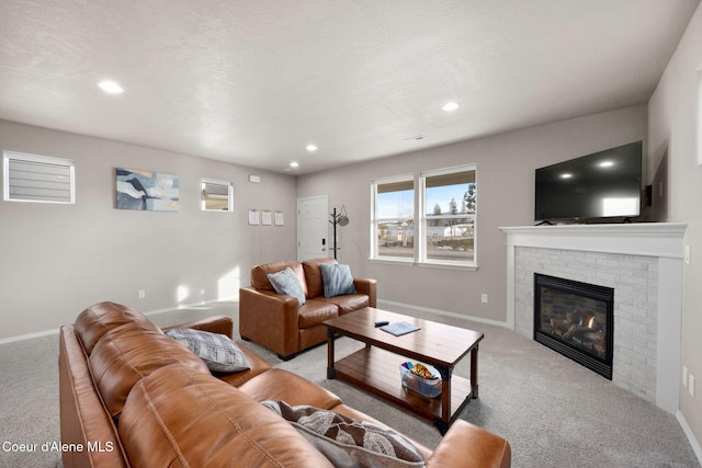 living area featuring baseboards, carpet, a textured ceiling, a brick fireplace, and recessed lighting