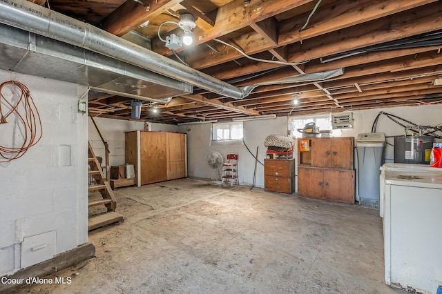 below grade area featuring stairs, visible vents, washer / dryer, and electric water heater