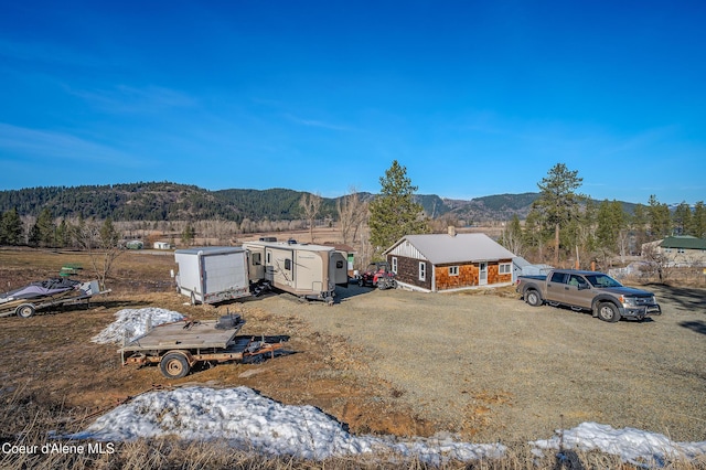 birds eye view of property with a forest view and a mountain view