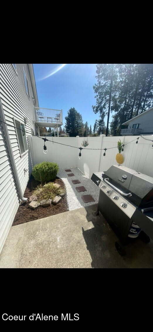 723 E Whispering Pines Ln # 17, Coeur Dalene, ID 83815 - fenced backyard featuring a patio