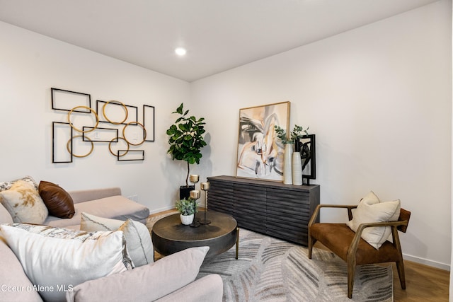 living room with light wood-type flooring, baseboards, and recessed lighting