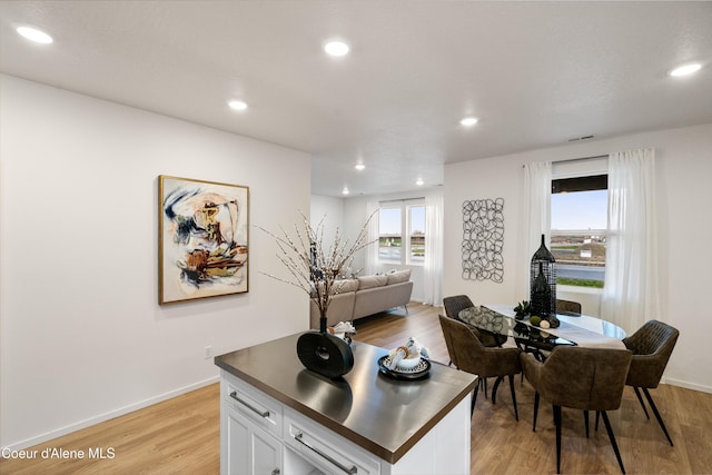 dining room featuring light wood-style floors, baseboards, and recessed lighting