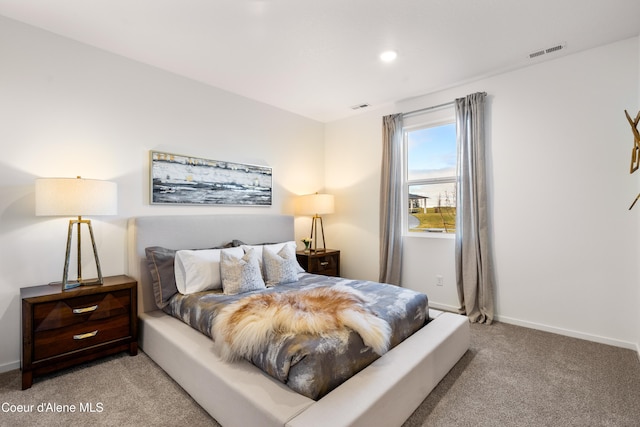 bedroom featuring light carpet, visible vents, and baseboards