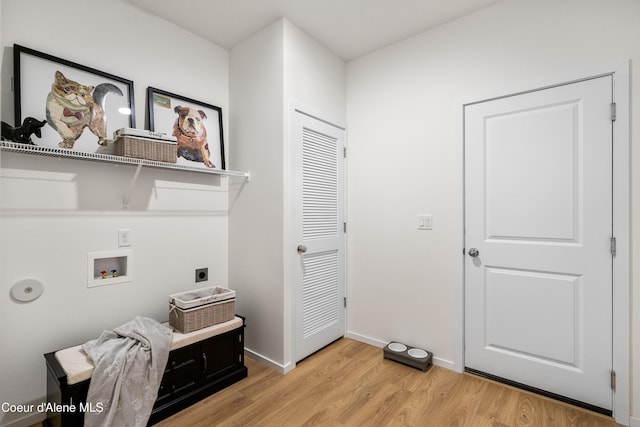 washroom featuring laundry area, baseboards, light wood-style floors, washer hookup, and electric dryer hookup