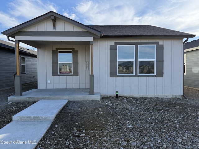 view of front of property featuring covered porch, a shingled roof, and board and batten siding