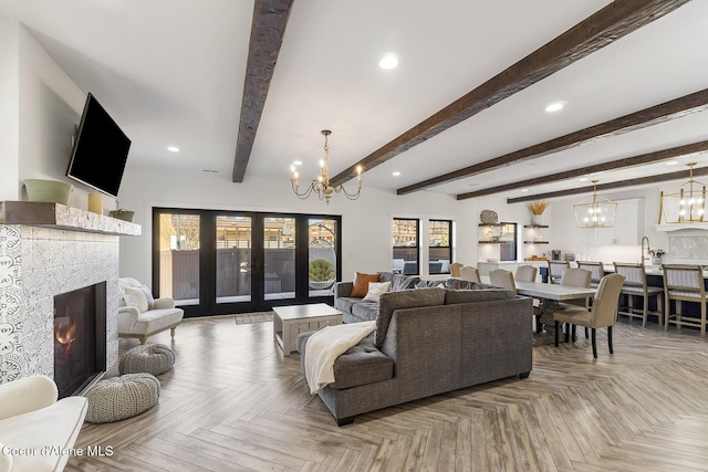 1853 W Felton Dr, Coeur Dalene, ID 83814 - living room featuring a warm lit fireplace, recessed lighting, a chandelier, and french doors