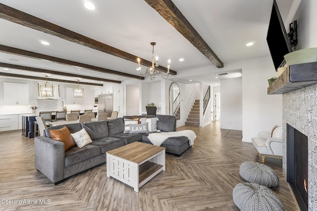1853 W Felton Dr, Coeur Dalene, ID 83814 - living room with recessed lighting, a notable chandelier, stairway, and a tiled fireplace