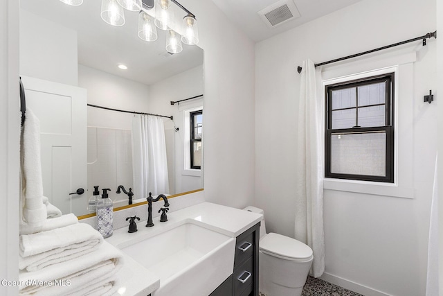 1853 W Felton Dr, Coeur Dalene, ID 83814 - full bathroom featuring visible vents, a shower with shower curtain, toilet, vanity, and baseboards