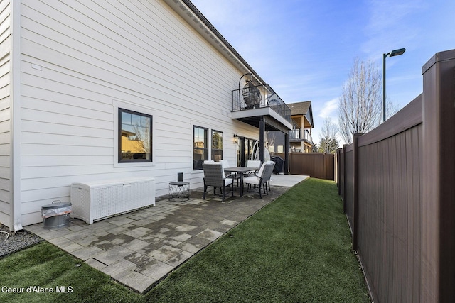1853 W Felton Dr, Coeur Dalene, ID 83814 - rear view of house featuring a yard, a patio area, a fenced backyard, and a balcony