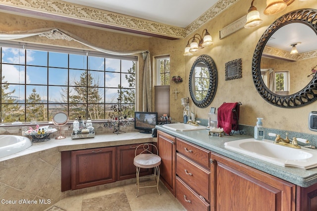 full bath with double vanity, a sink, a bathtub, and wallpapered walls