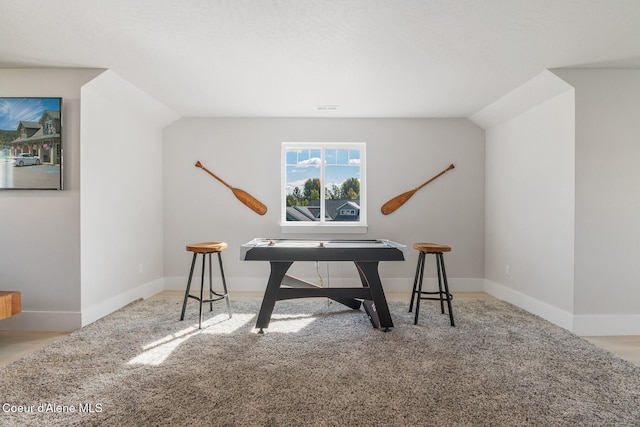 office with visible vents, baseboards, vaulted ceiling, and carpet floors