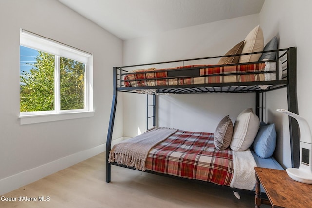 bedroom with baseboards and wood finished floors