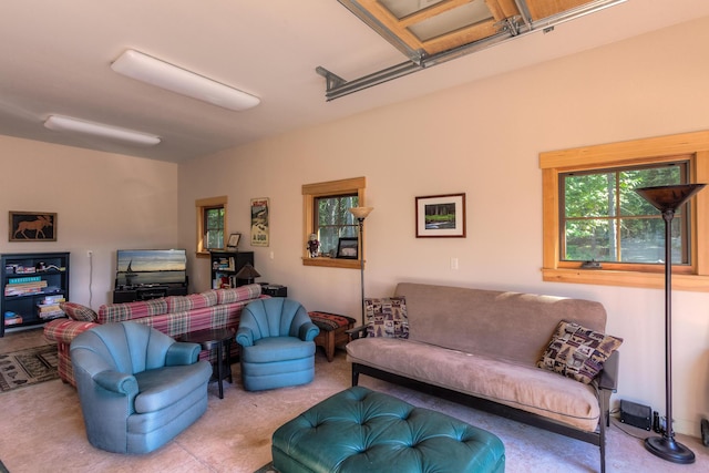 carpeted living area with a garage