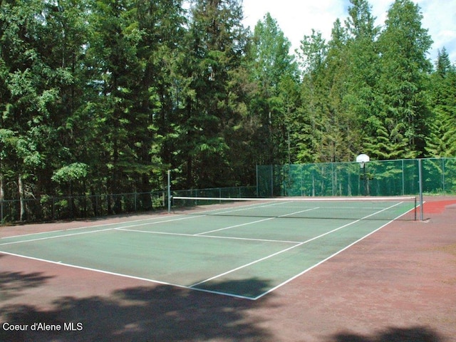 view of sport court featuring fence