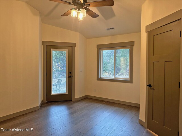 entryway featuring wood finished floors, a ceiling fan, and baseboards